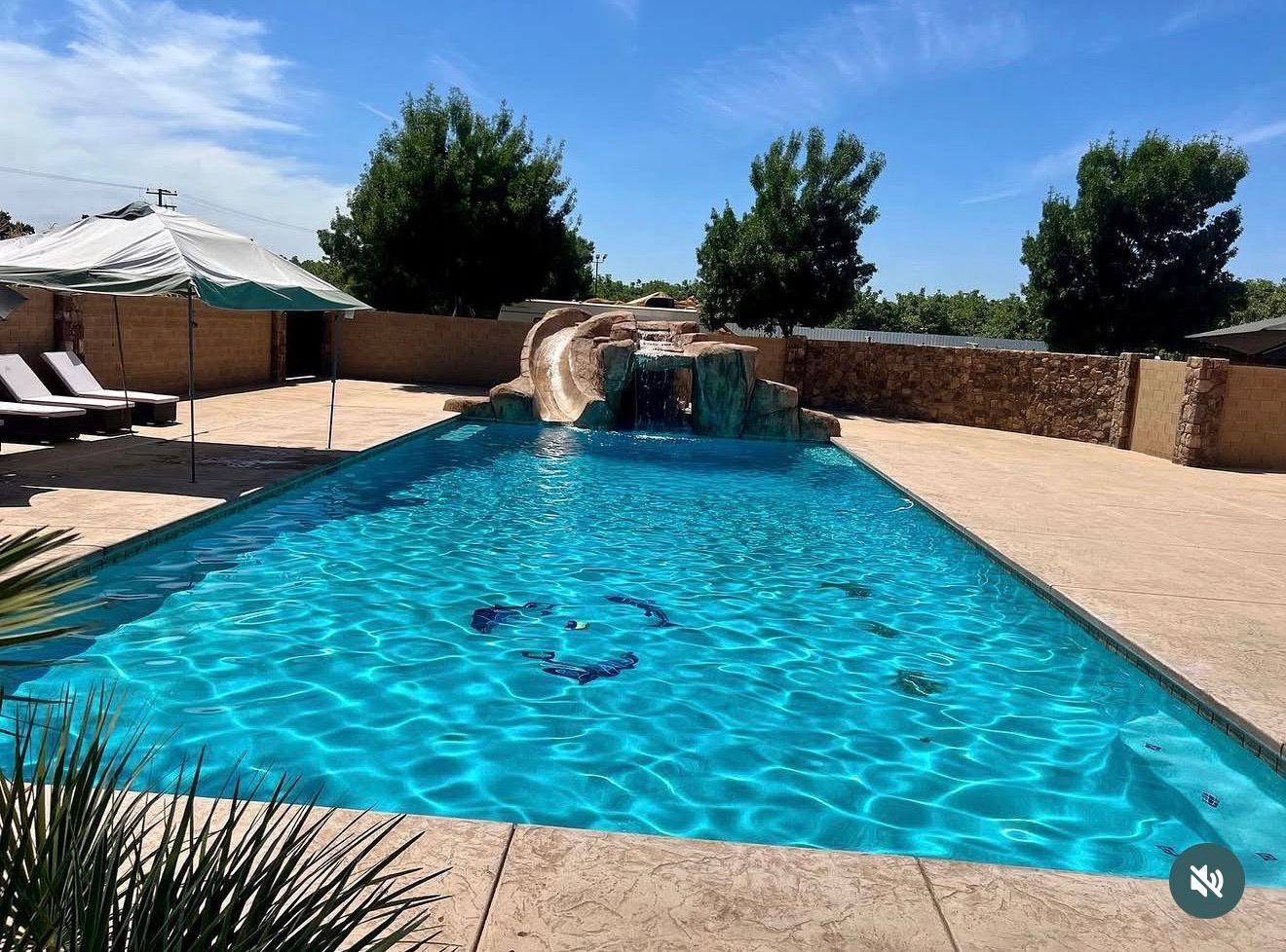 Pool with rock waterslide feature